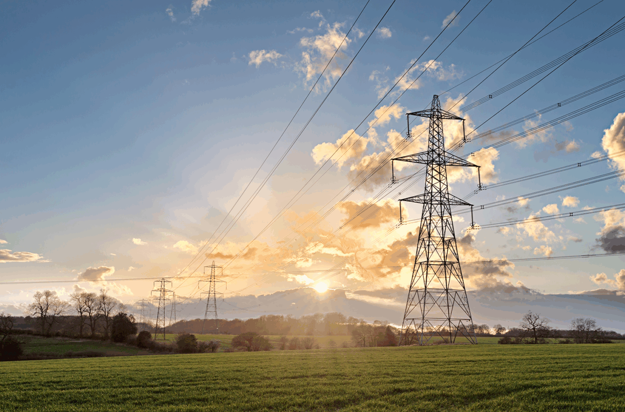 UK standard overhead power line transmission tower at sunset