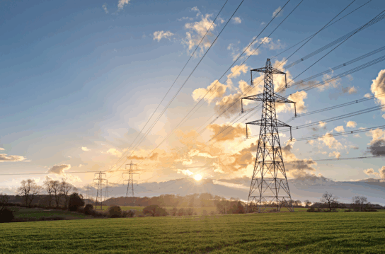 UK standard overhead power line transmission tower at sunset